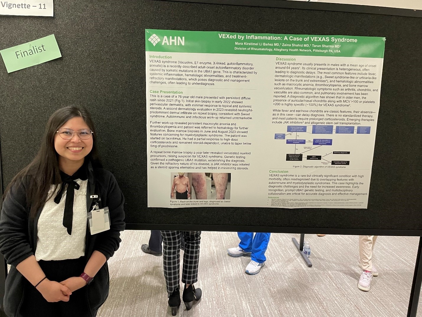 fellow standing by poster at MI Research Day