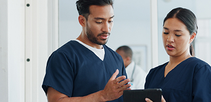 Two ASH schools of nursing students reviewing a chart. 