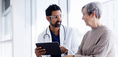 physician showing a patient information on a tablet device