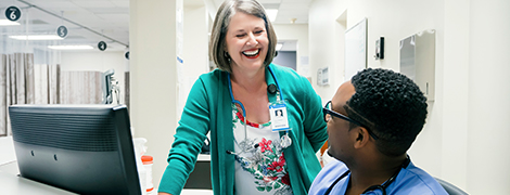 A nurses talking to her colleague.