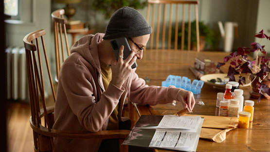 An AHN patient talking to someone on the phone about his medicine.