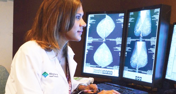 AHN provider looking at xray images on computer screen