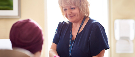 A nurse helping a patient at the AHN After Hours Oncology Clinic.