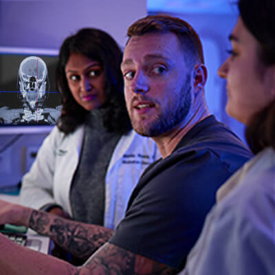 Medical team views 3D scan with a patient