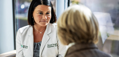 An oncologist looking at a patient