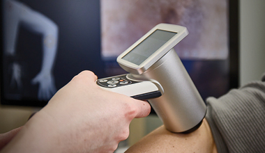 Doctor using a handheld device for detailed skin examination.