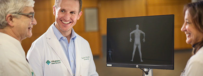 AHN doctors reviewing a 3D scan for squamous cell skin cancer diagnosis.