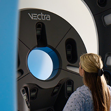 Patient undergoing a VECTRA 3D imaging scan for targeted radiation therapy planning for squamous cell skin cancer.