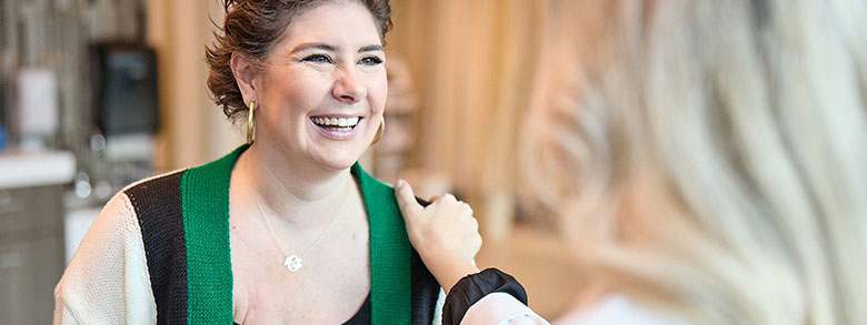 AHN cancer specialist talking to a patient and putting her hand on the patient shoulder.