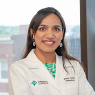 doctor and researcher smiling in front of window