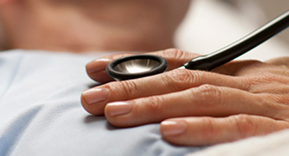 image of a doctor listening to heart with stethoscope