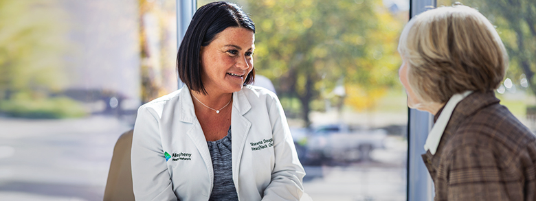 A female medical professional speaks to a patient.